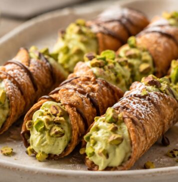 Mini cannoli bites filled with pistachio mascarpone cream and topped with chopped pistachios
