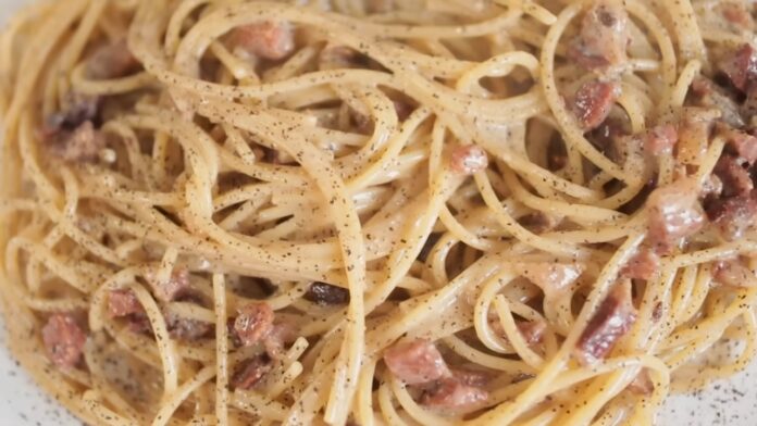 Spaghetti alla Carbonara Recipe Creamy spaghetti carbonara with bacon pieces and black pepper